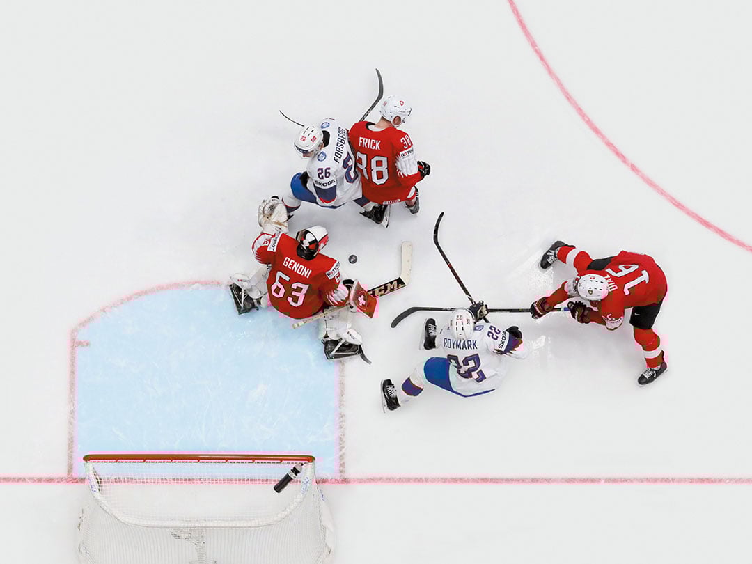Goal action during an ice hockey match illustrating the sporting partnership between Tissot and the IIHF.