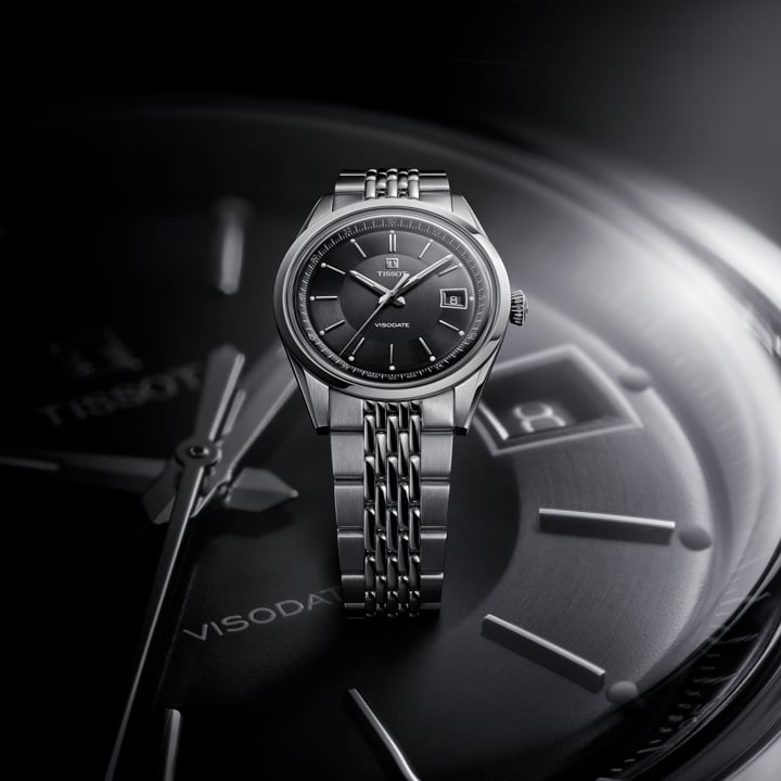 The visodate with a black dial above a zoomed in visodate