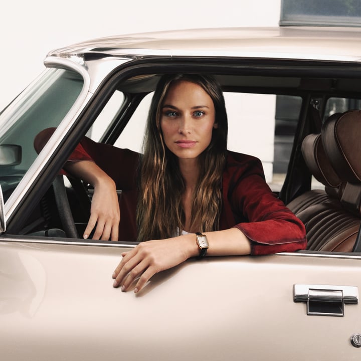 Model Agathe Teyssier sat in a car wearing a Tissot SRV