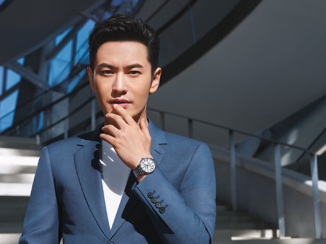 Huang Xiaoming in a blue suit wearing a Tissot Le Locle