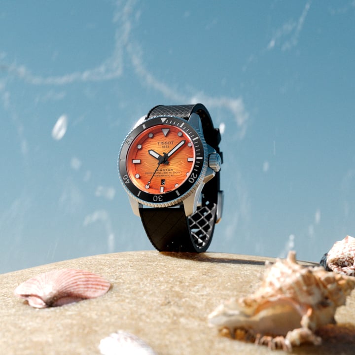 Tissot Seastar watch on a beach with seashells
