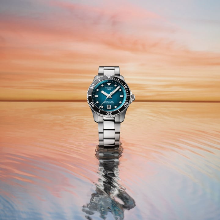 Stainless steel watch with carious straps floating in water