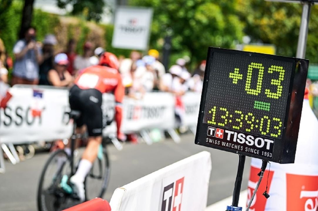 A Tissot-branded race timing display showing time as a cyclist passes by during a race.