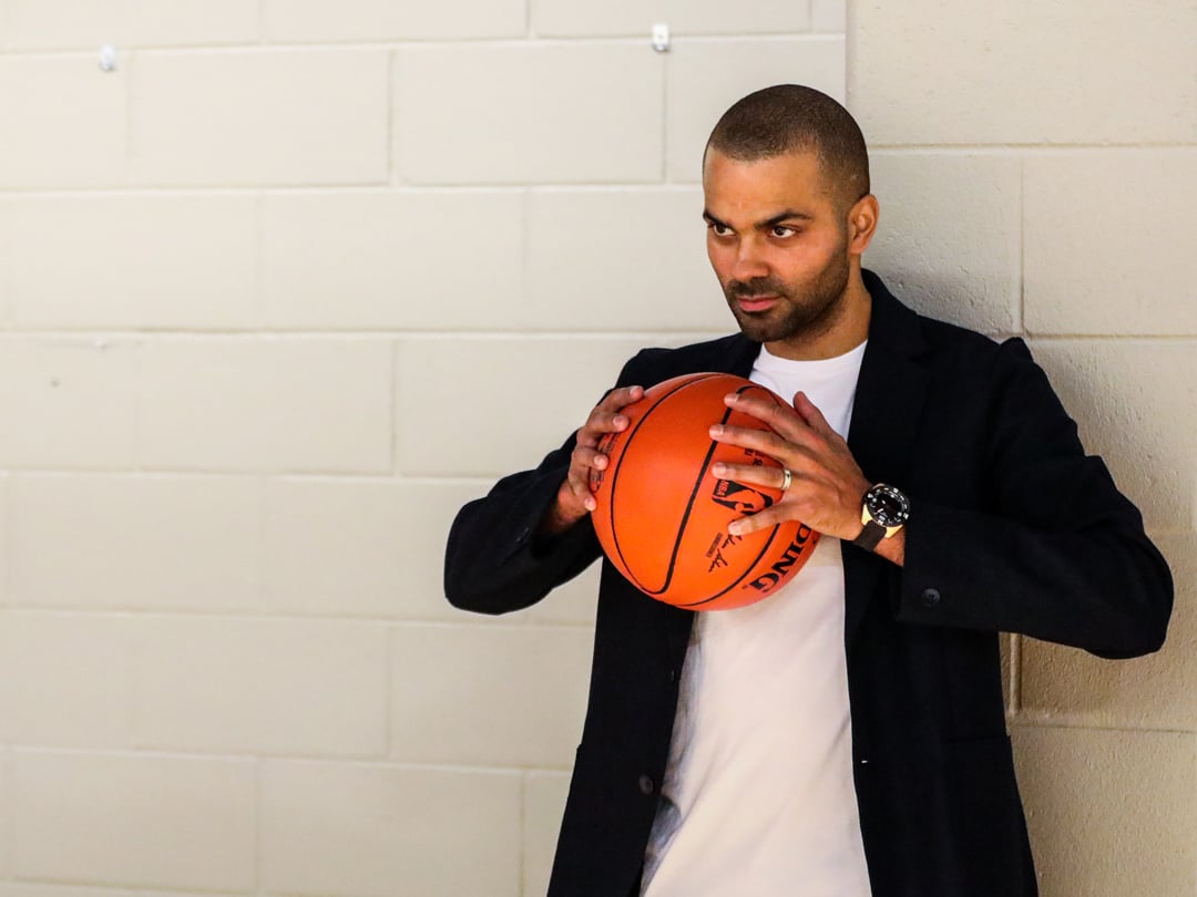 Tony Parker holding a basketball and wearing a Tissot watch