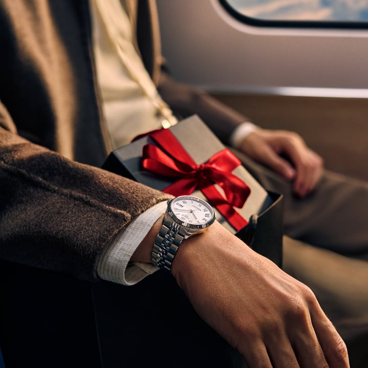 Man in a red car wearing a PR516 watch on his wrist