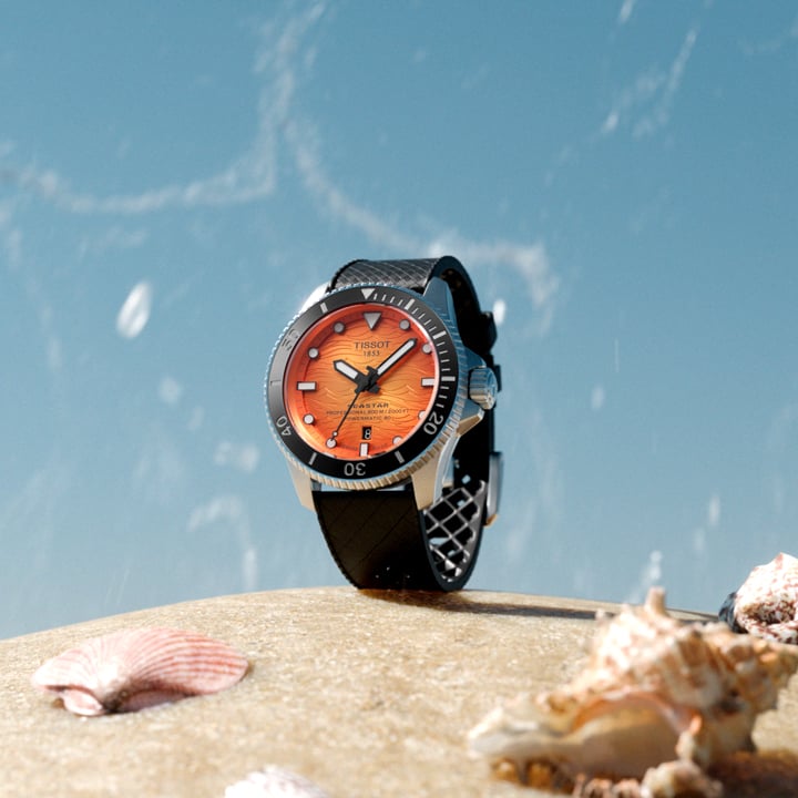 the Seastar Pro 2000 Orange on sand with seashell near by