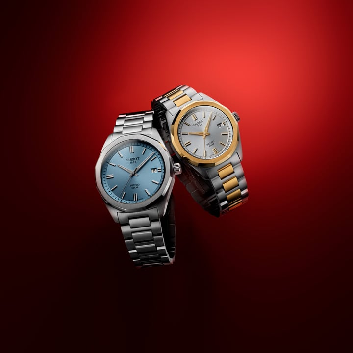 Close up of a Tissot  PRC 100 Solar duo in front of red backgournd