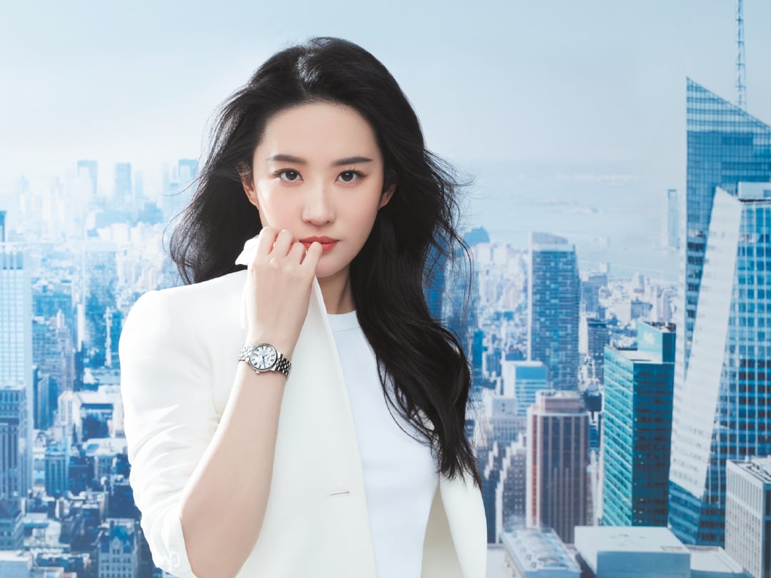Liu Yifei in a white shirt posing wearing a Tissot watch