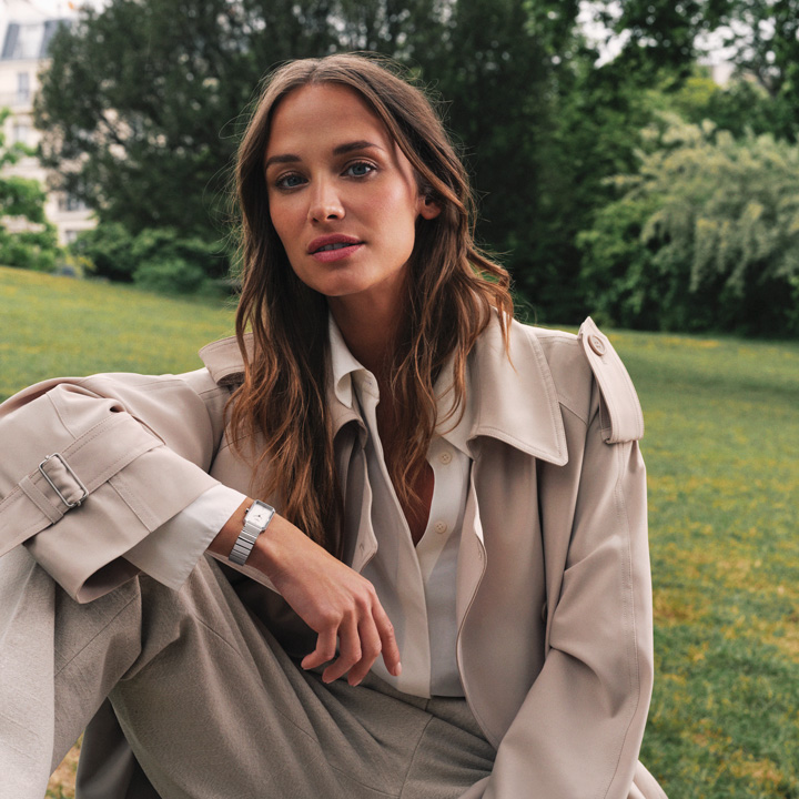 Agathe Teyssier sitting in a park and wearing the new Tissot SRV