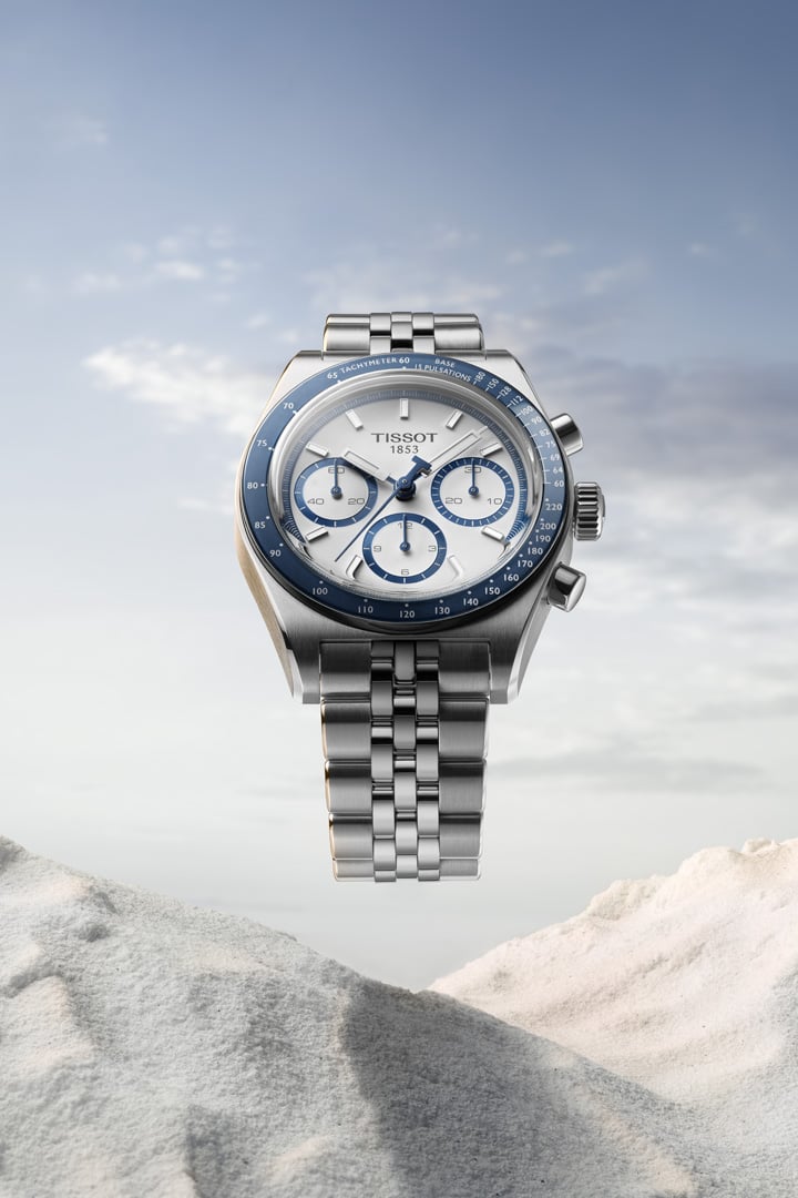 Men driving a red car, wearing a PR516 watch