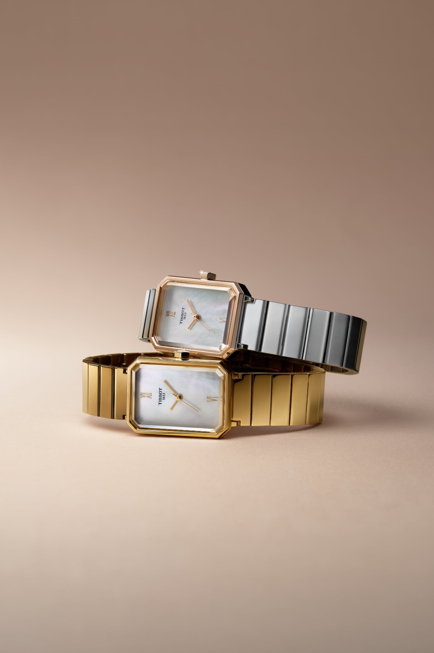 Two Tissot SRV watches with signature rectangular faces and iridescent mother-of-pearl dials, displayed against a warm neutral background. The top watch features a rose gold-tone bezel and silver stainless steel link bracelet, while the bottom model is finished in a full yellow gold-tone.